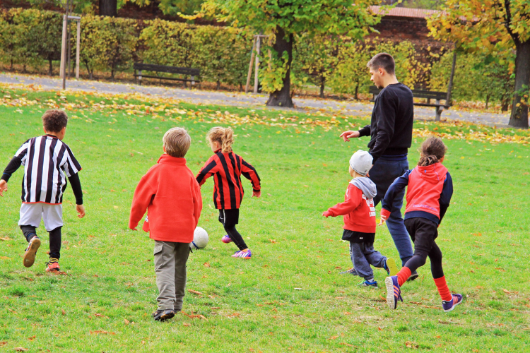 children are playing football in city park vienna
